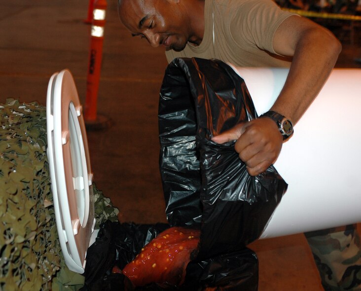 Before individuals could “proceed to the Grog,” it was cleaned, filled with leaded and unleaded beverages, and inspected. Airmen “convicted of breaking the rules of engagement” were sent to the Grog via an obstacle course. The Rising 6 sponsored an Enlisted Combat Dining-In April 27. (U.S. Air Force photo by Staff Sgt. Candy Knight)