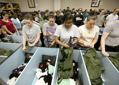 Air Force basic trainees from the 331st Training Squadron's Flight 392, unload their duffel bags and check their issued items May 2 at Lackland Air Force Base, Texas. The flight's first day of Basic Military Training is May 7. They are scheduled to graduate June 15. (U. S. Air Force photo/Robbin Cresswell)