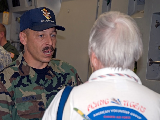 Senior Master Sgt. Rod Benefiel, 437th Maintenance Group production superintendent, talks with a family member of one of the Flying Tigers on a C-17 during the reunion. (U.S. Air Force photo/Senior Airman Sam Hymas)