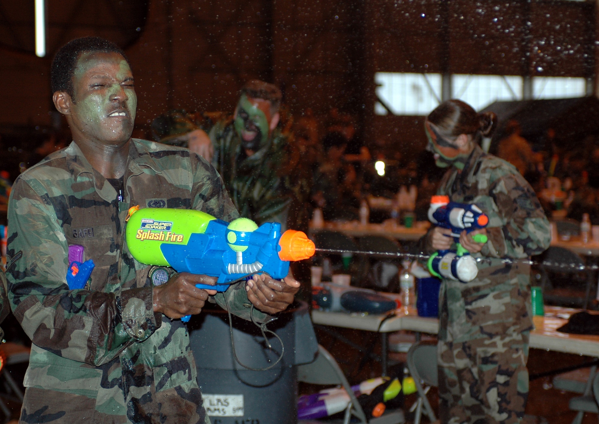 Airman Mananitom Bafei, 60th Logistics Readiness Squadron, fires his weapon during the Enlisted Combat Dining-In April 27. More than 500 enlisted members of Team Travis attended the event. (U.S. Air Force photo by Tech. Sgt. Donald Osborn)