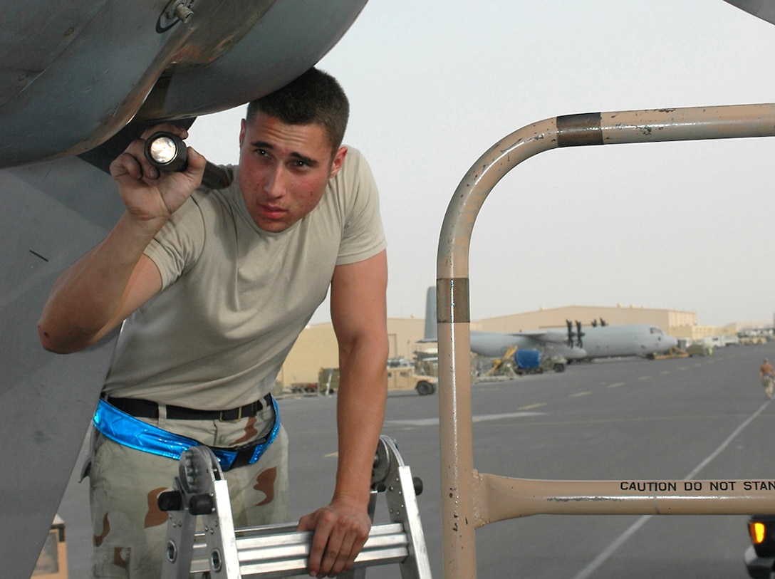 Senior Airman Michael Sevilla performs a post-flight inspection on a C-130 Hercules in Southwest Asia. C-130 crews from the United States, Australia, Canada and Iraq support airlift and passenger movement requirements in both Iraq and Afghanistan every day. Airman Sevilla is a 379th Expeditionary Aircraft Maintenance Squadron crew chief. (U.S. Air Force photo/Senior Airman Erik Hofmeyer)