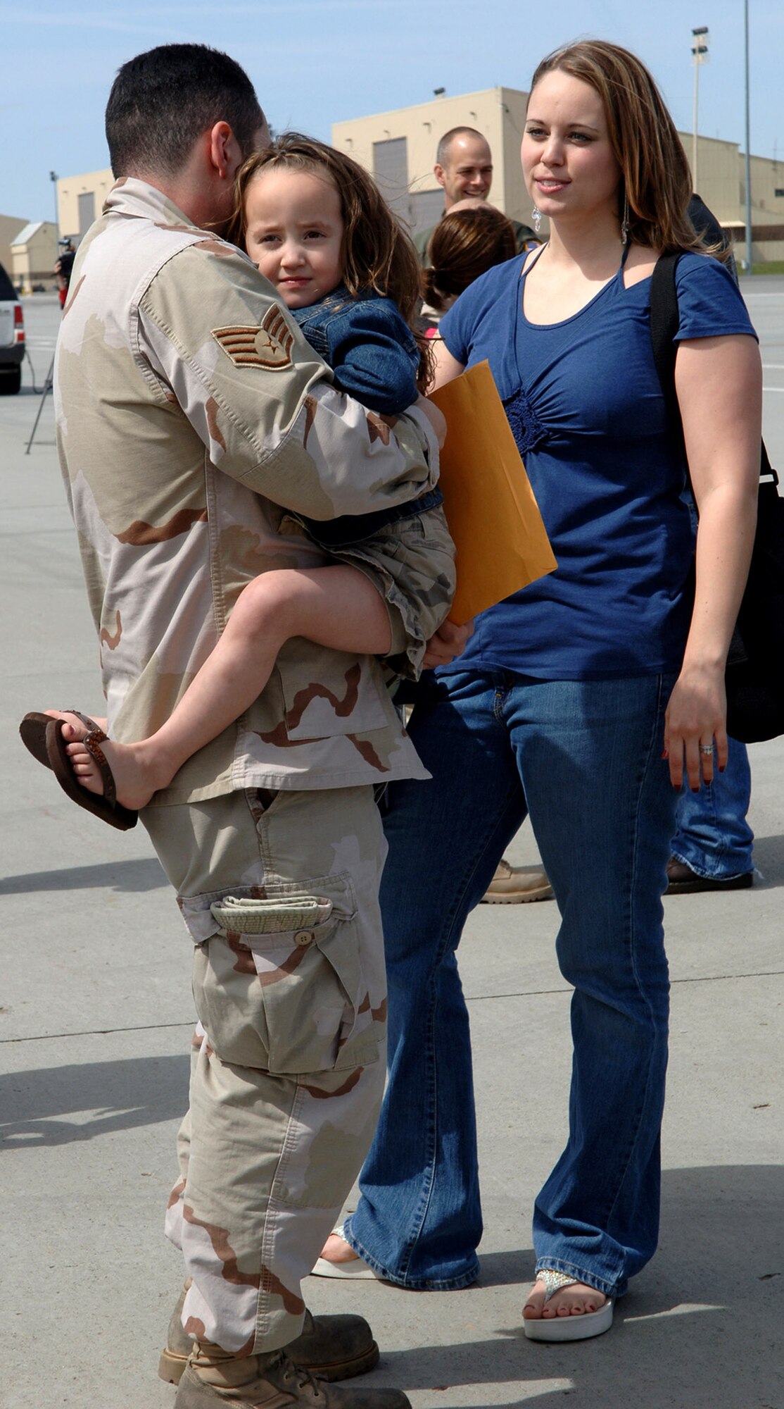 Jasmine Hernandez receives a big hug from her father, Tech. Sgt. Juan Hernandez, just minutes after his return April 30 to Fairchild Air Force Base, Wash. Sergeant Hernandez returned with 44 other Airmen from Manas Air Base, Kyrgyzstan. (U.S. Air Force photo/Airman 1st Class Jocelyn Ford) 