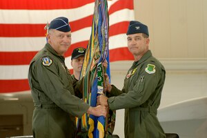 LANGLEY AIR FORCE BASE, Va. -- Col. Mark A. Barrett, the new 1st Fighter Wing commander, accepts the 1st Fighter Wing flag from Lt. Gen Gary North, commander of 9th Air Force and U.S. Air Forces Central, during the change of command ceremony here April 30. (USAF Photo by Tech Sgt Levi Collins)