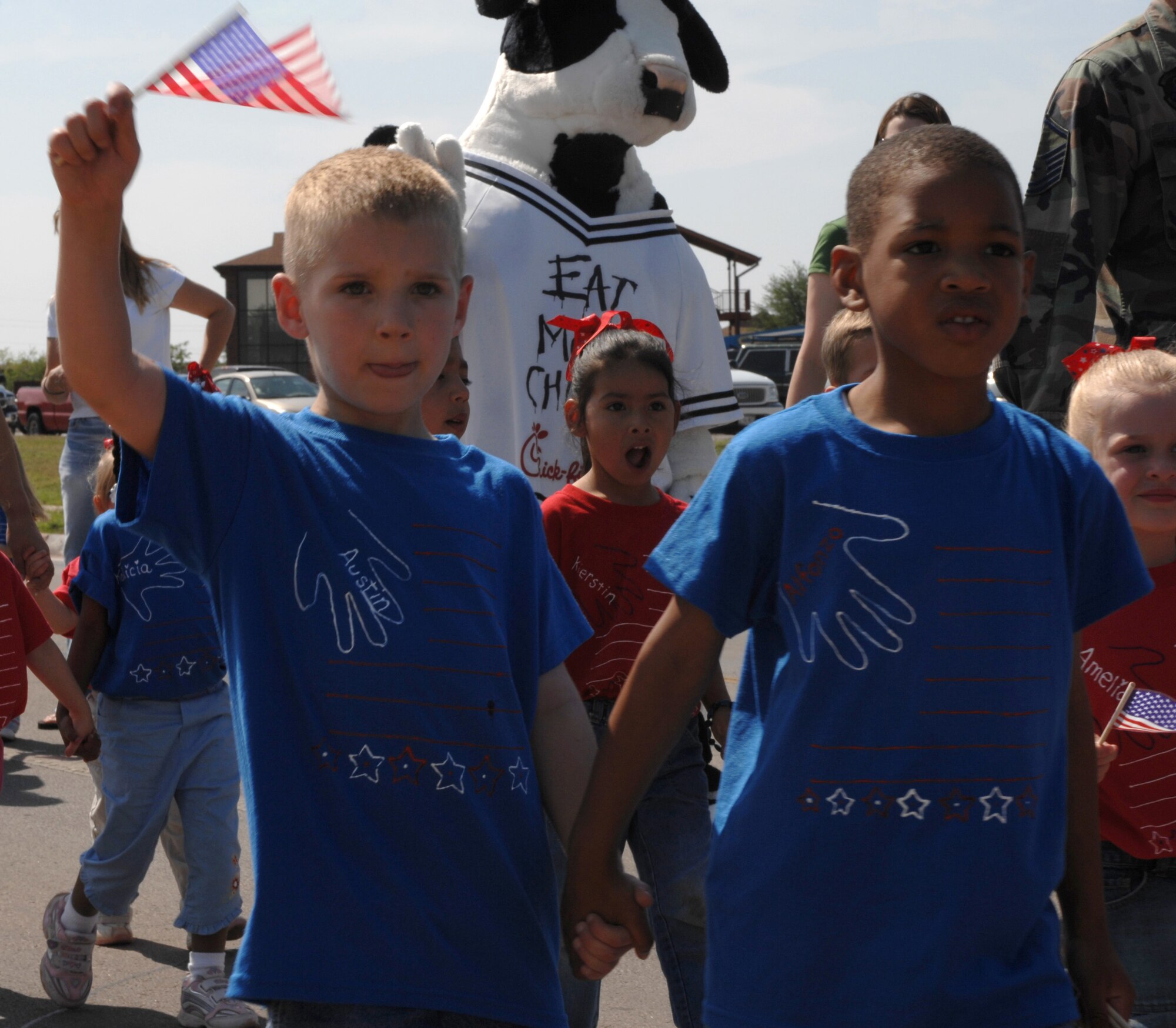 Austin Jackson (left), 4, and Alfonzo Pater, 4, walk in support of the Month of the Military Child during the Child Development Center's parade April 27. (U.S. Air Force photo by Senior Airman Courtney Garrard)