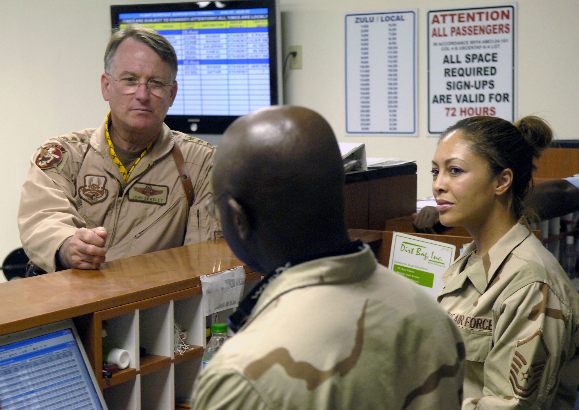 Lt. Gen. John Bradley, left, commander of Air Force Reserve Command and chief of the Air Force Reserve, listens to Senior Airman Michael Sanders Jr. and Master Sgt. Chandra Sutton Aug. 29, 2006, at the airlift passenger terminal, Bagram Airfield, Afghanistan.  The general will visit Whiteman Air Force Base, Mo., May 5 to present the Meritorious Unit Award to reservists from the 442nd Fighter Wing who were deployed to Afghanistan last summer.  (U.S. Air Force photo/Senior Airman Brian Ferguson)