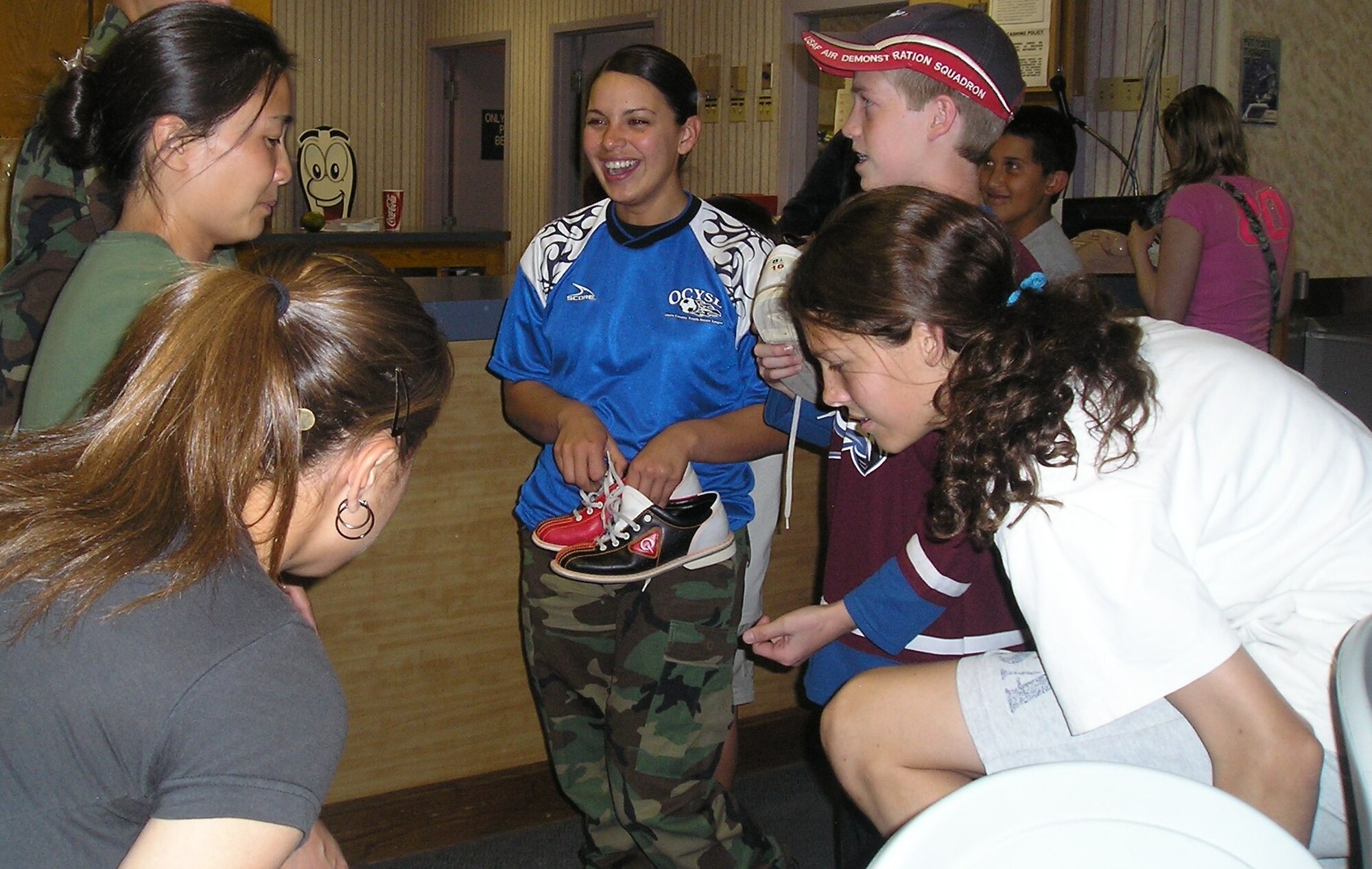 Airman 1st Class Cindy Ventura, 49th Aeromedical Dental Squadron, chats with members of the Holloman Air Force Base soccer team at the Desert Lanes Bowling Alley Monday. Airman Ventura served as head coach of the team. The team celebrated the end of the soccer season with bowling. (U.S. Air Force photo by Tech. Sgt. Ray Bowden)