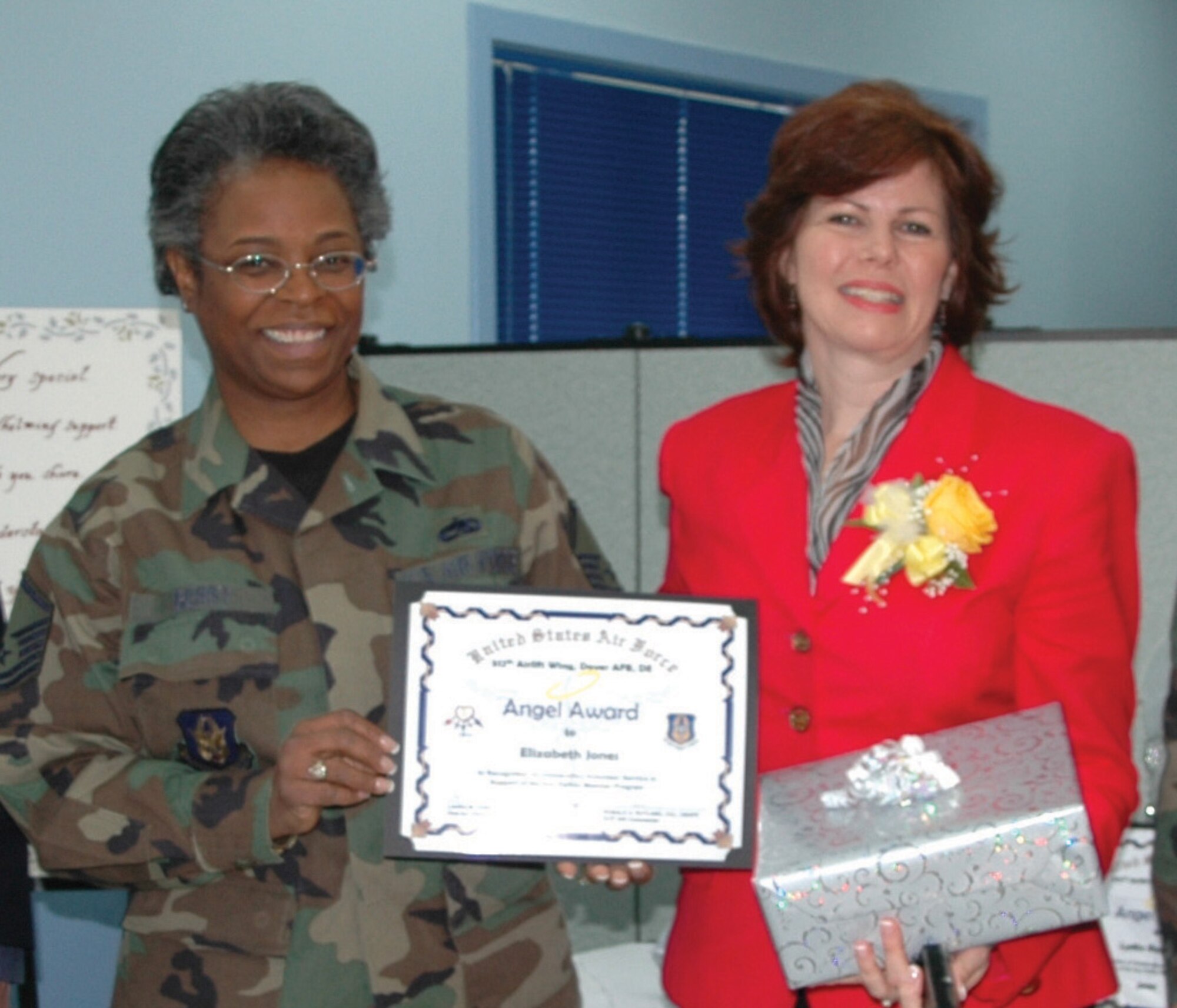 DOVER AIR FORCE BASE, Del. -- Master Sgt. Linda Berry (left), 512th Airlift Wing Family Support Center, recognized Liz Jones April 14 for her help with the wing's Key Family Member Program. Mrs. Jones is the wife of Lt. Col. Kurt Jones, 709th Airlift Squadron. The 512th AW is an Air Force Reserve Command unit. (U.S. Air Force photo/Tech. Sgt. Veronica A. Aceveda)