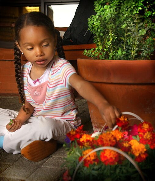 Jayla Mosley, 4, daughter of Airman First Class Marlon Mosley, 352nd Maintenance Squadron, helps arrange flowers during the Earth Week activities at the RAF Mildenhall Child Development Center April 26. (U.S. Air Force photo by Staff Sgt. Tyrona Pearsall)                                    