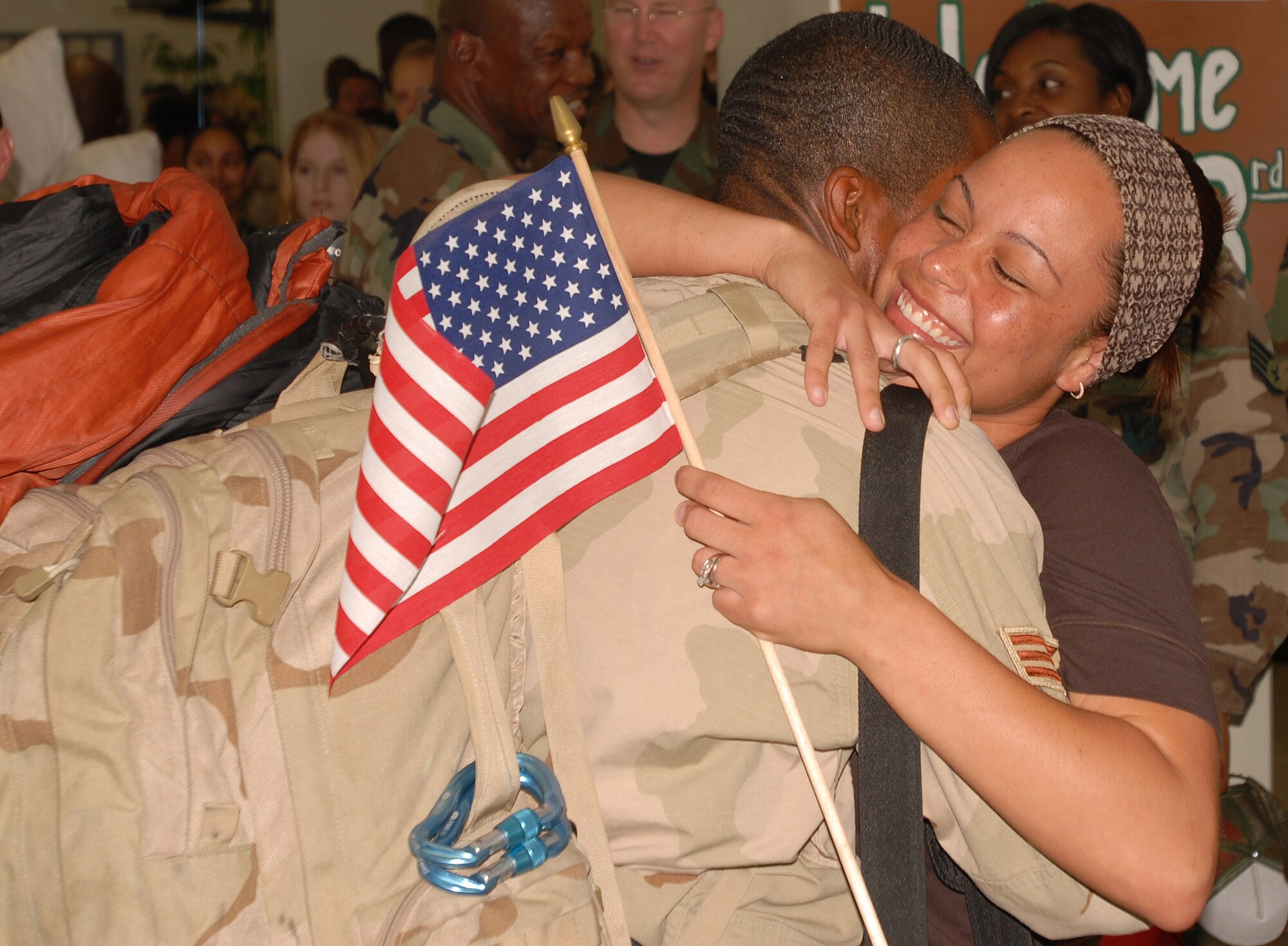 Senior Airman Perris Coleman of the 18th Equipment Maintenance Squadron at Kadena Air Base, Japan, embraces his wife after returning from a 120-day deployment to Kandahar, Afghanistan.  Airman Coleman was deployed with Kadena’s  33rd Rescue Squadron. While in Afghanistan, the 33rd Rescue Squadron saved 116 lives and flew more than 200 sorties.  Dozens of Airmen from Kadena’s 718th Aircraft Maintenance and the 18th EMS were also deployed with the 33rd RQS.  (U.S. Air Force photo by Airman 1st Class Ryan Ivacic)