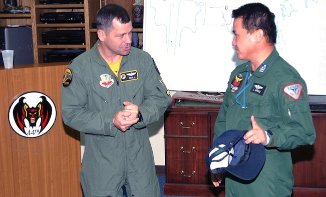 Lt. Col. Wade Tolliver (left) greets Japanese Air Self Defense Force (JASDF) Col. Junichi Araki at the 44th Fighter Squadron April 27, 2007, at Kadena Air Base, Japan.  Air Force and JASDF officers gathered to debrief after conducting dissimilar air combat training between U.S. F-22s and F-15s and JASDF F-4s and F-15s.  Colonel Tolliver is the 27th Fighter Squadron commander deployed here from Langley Air Force Base, Va.  Colonel Araki is the Defense Chief for Southwest Air Division at Naha Air Base on Okinawa.  (U.S. Air Force Photo by Airman 1st Class Kasey Zickmund)