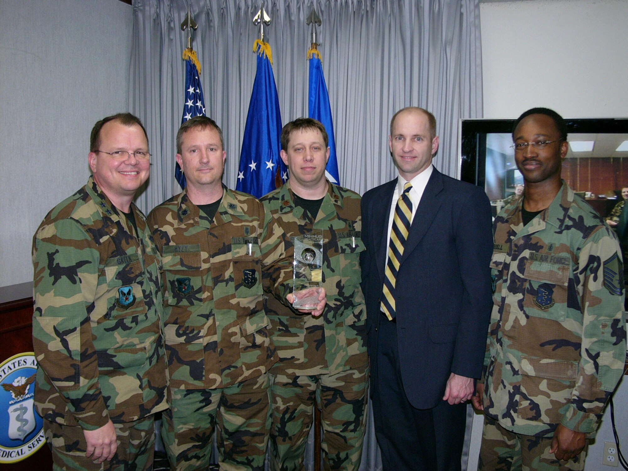 Maj. Gen. (Dr.) Bruce Green, Air Force deputy surgeon general, (far left) stands with members of the data modeling and analysis team. Pictured  from Green's left are: Lt. Col. Jerome Hyzy, Maj. Ted Woolley, Mr. Rick May and Master Sgt. Cris Coerbell. (U.S. Air Force courtesy photo)