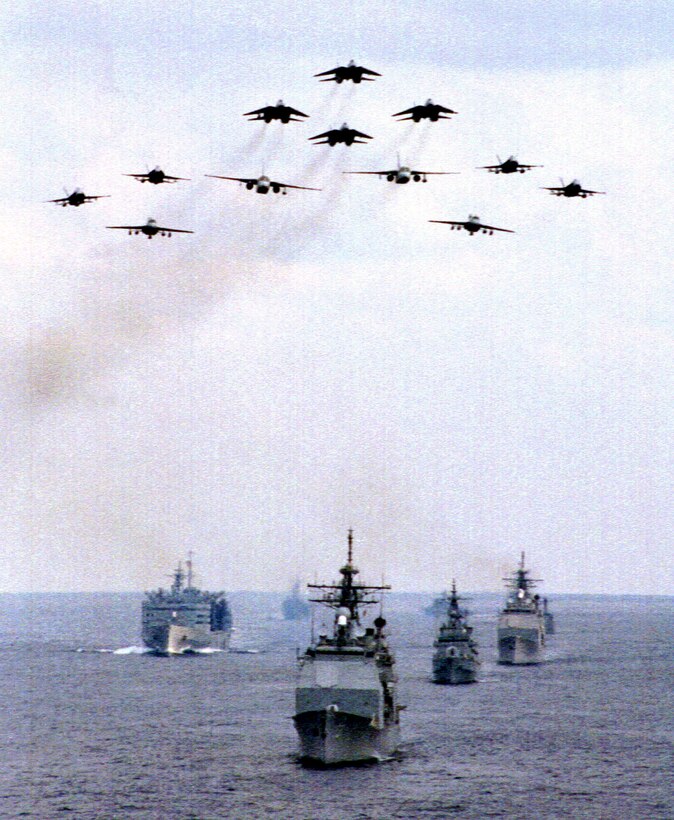 Aircraft of Carrier Airwing 9 fly in formation over ships of the USS John C. Stennis Carrier Battle Group and the South Korean navy. The Stennis was host to South Korean officials Feb. 1. The battle group is currently operating in the Arabian Gulf in support of Operation Southern Watch. Photo by Petty Officer 3rd class Brian A. Dunn, USN. 