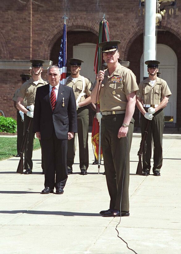 Marine Corps commandant Gen. James Jones recognizes the accomplishments of retired Army Gen. John H. Tilelli during an award ceremony at the Marine Barracks in Washington. Jones presented the new USO director with a Distinguished Service Medal April 5 for his service in South Korea as commander in chief of the U.N. Command, Combined Forces Command and U.S. Forces Korea from July 1996 until he retired Jan. 31. Marines comprised 40 percent of Tilelli's last command. Photo by Cpl. Jacob A. Fuller, USMC. 