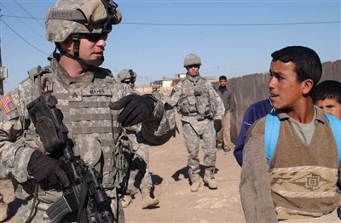 U.S. Army Sgt. Frankie Maher (left) talks with Iraqi children in Musayd, Iraq, on April 25, 2007, during a mission to learn about living conditions in the area.  Maher is assigned to Bravo Company, 2nd Battalion, 7th Cavalry Regiment, 4th Brigade Combat Team, 1st Cavalry Division.  