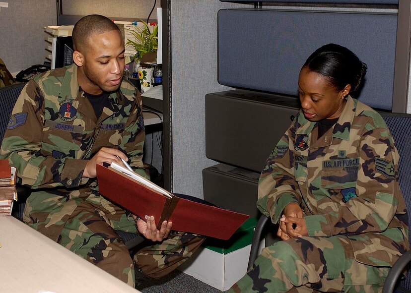 Staff Sergeant Kamau Joseph, non-commissioned officer in charge of TRICARE, 8th Medical Support Squadron, talks with another medical group sergeant in his office May 1. He was awarded a Pride of the Pack certificate for his stellar commitment to excellence and superior mission accomplishment. The certificates are awarded weekly to the Wolf Pack's top performers. (U.S. Air Force photo by Staff Sgt. Darcie Ibidapo.)            