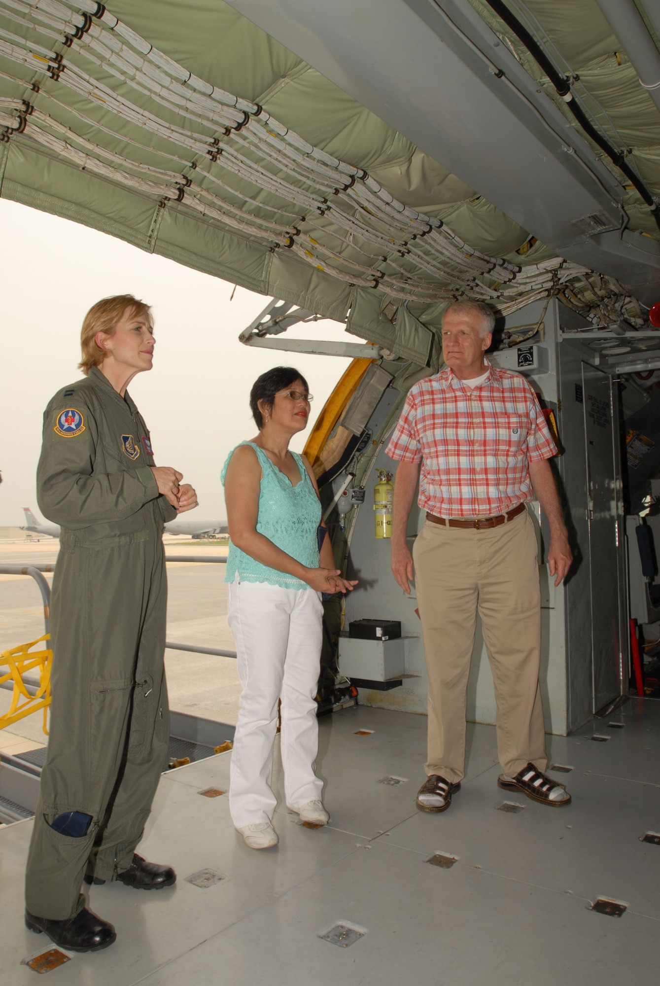 Capt. Jeannette Ward (left) talks with Jim and Marite Brierly about where Mr. Brierly's medical evacuation litter was on a KC-135 at Kadena Air Base, Japan, on May 2, 2007.  Captain Ward was part of the team that treated and medically evacuated Mr. Brierly to Hawaii after he suffered a major heart attack in March 2006.  Mr. and Mrs. Brierly visited the units to thank them for their efforts.  Mr. Brierly teaches English as a second language teacher at Kadena Elementary School.  Captain Ward is a flight nurse with Kadena's 18th Aeromedical Evacuation Squadron.  (U.S. Air Force photo by Airman 1st Class Kasey Zickmund)