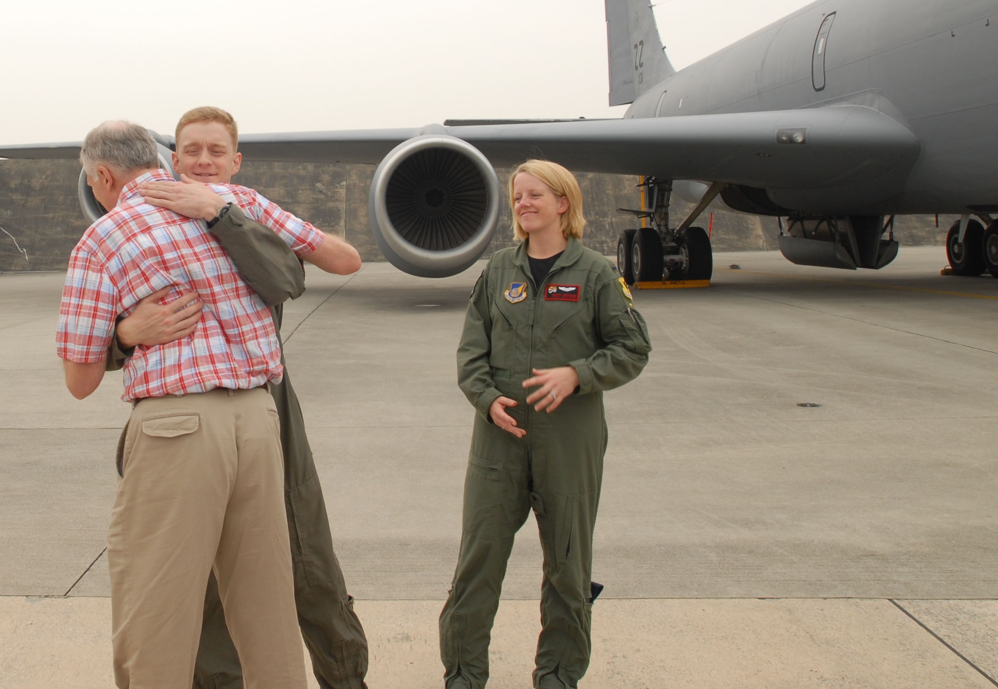 Jim Brierly hugs Capt. Dan Bradford as 1st Lt. Marta Lofthouse looks on at Kadena Air Base, Japan, on May 2, 2007.  Captain Bradford and Lieutenant Lofthouse were the pilots who flew the KC-135 that medically evacuated Mr. Brierly to Hawaii after he suffered a major heart attack.  Mr. Brierly and his wife, Marite, visited the units to thank them for their efforts.  Mr. Brierly teaches English as a second language at Kadena Elementary School.  Both officers are with the 909th Air Refueling Squadron. (U.S. Air Force photo by Airman 1st Class Kasey Zickmund)