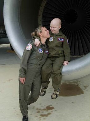 ANDREWS AIR FORCE BASE, Md. -- Capt. Susanne Schulz, 113th Airlift Wing Pilot for a Day (P4D) coordinator, exchanges smiles in the engine of a KC-135 Stratotanker with 8-year-old Sam Gates, who was diagnosed with leukemia last year. Members of the 459th Air Refueling Wing joined forces with the National Guard's 113th AW to host P4D. The program allows children with serious diseases to visit the wing and tour aircraft, the fire station, watch military working dogs and mingle with pilots and aircrew. The 459th ARW is a Reserve component of the U.S. Air Force. (U.S. Air Force photo by Staff Sgt. Amaani Lyle)
