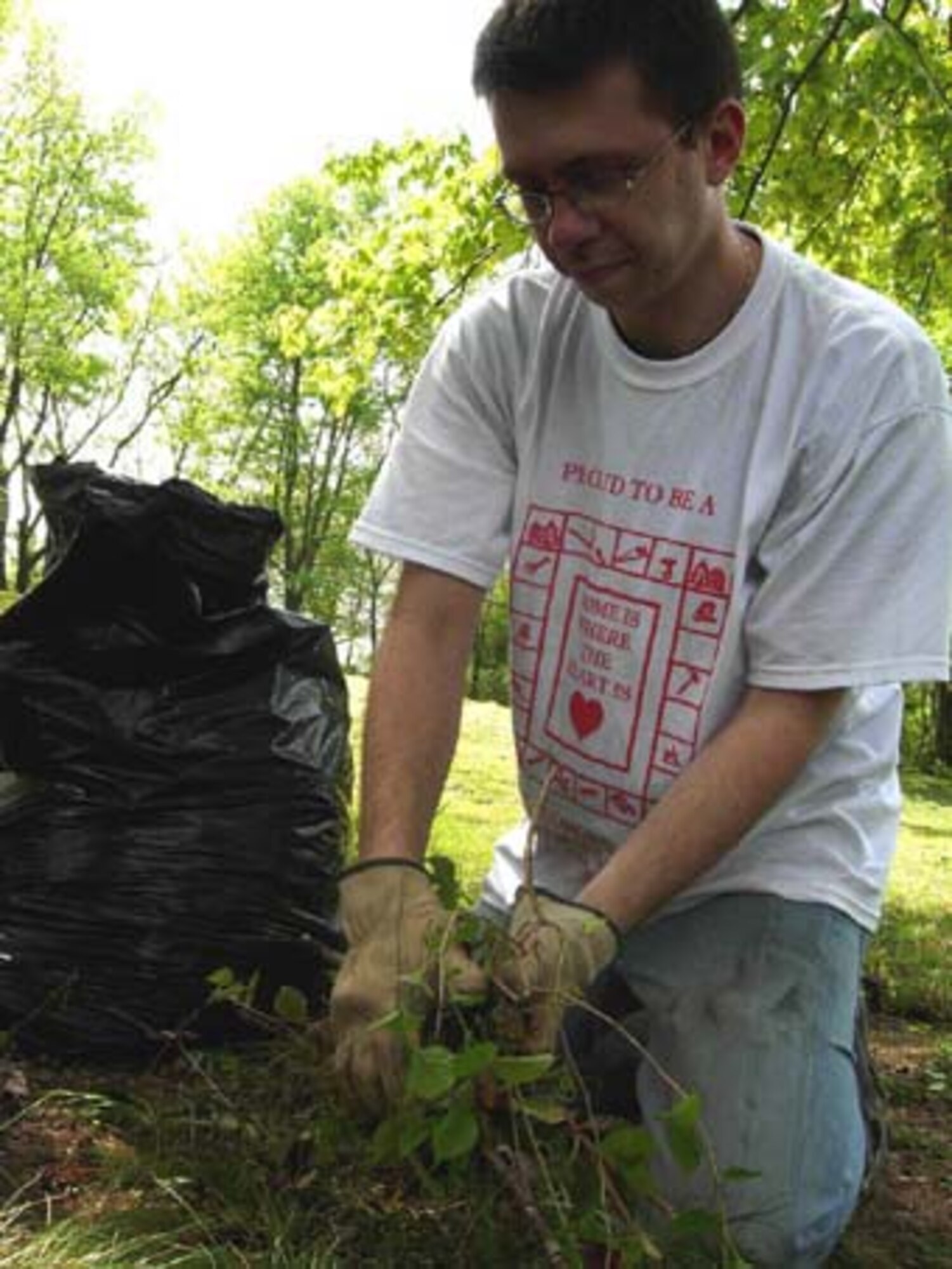 CAPITOL HEIGHTS, Md. -- Senior Airman Daniel McEvily, 69th Aerial Port Squadron transportation specialist, finishes some backyard work during "Christmas in April" April 28. The program helps local residents through volunteer participation in cleaning, repairs, yardwork, painting or any other needs the homeowner may have. Typical resident candidates for home makeovers are elderly, disabled, low-income or a combination of all. This year, the 459th Air Refueling Wing sent more than 30 volunteers to help improve an area home. The 459th ARW is a Reserve component of the USAF. (U.S. Air Force photo/Staff Sgt. Amaani Lyle)