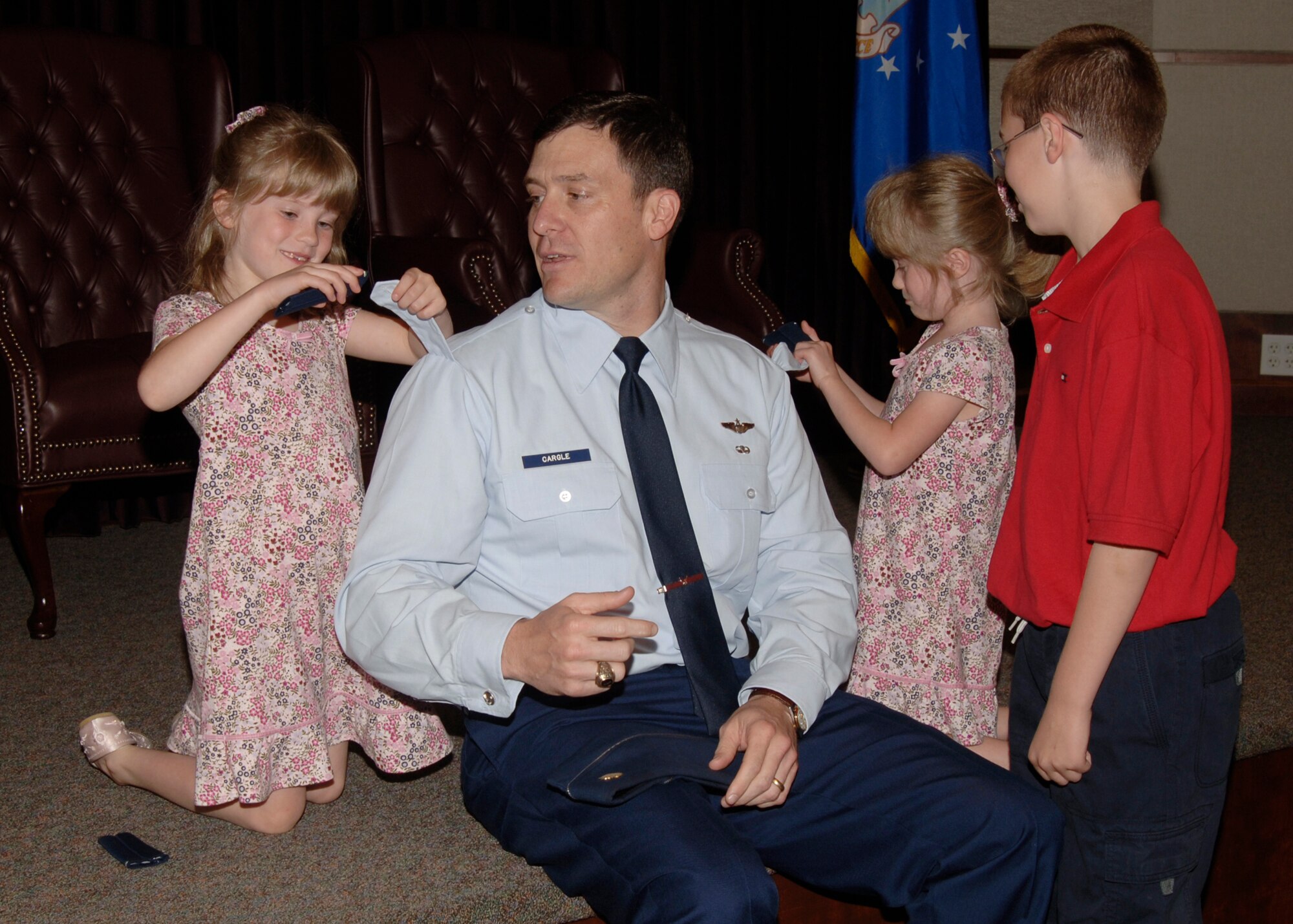 Maj. Barry Cargle, Chief, 22nd Air Refueling Wing command post chief, promotes to lieutenant colonel with help from his children: Lindsey, Megan and Timothy, during his promotion ceremony, May 1, at the 384th Air Refueling Squadron auditorium. (photo by Airman 1st Class Jessica Corob)