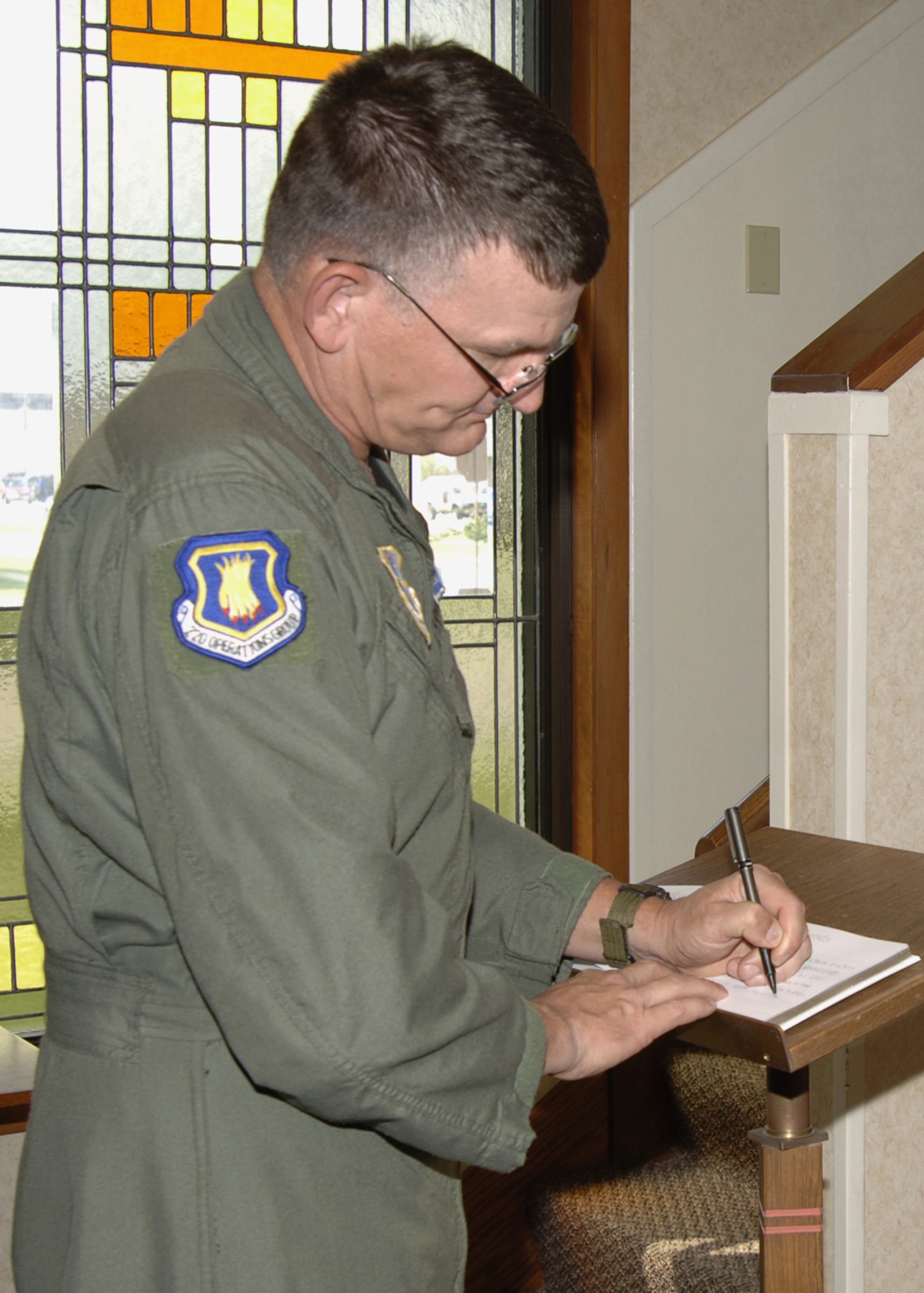 Chief Master Sgt. James Morman, 22nd Operations Group, signs a memorial service guest book at the base chapel, April 26, honoring retired Staff Sgt. John Heath who passed away from Lou Gehrig’s disease April 17, at a hospital in Ellenton, Fla., where he lived. Sergeant Heath was a former aircraft maintainer, at the 22nd Aircraft Maintenance Squadron here.