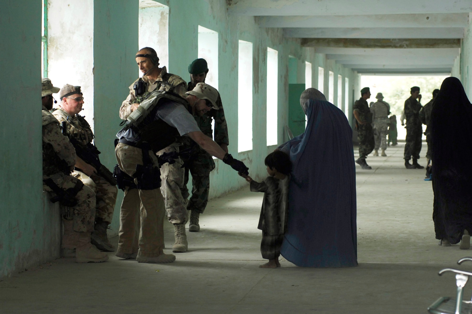 Air Force Office of Special Investigations special agents greet an Afghani child while conducting counter intelligence in Afghanistan. (U.S. Air Force photo)
