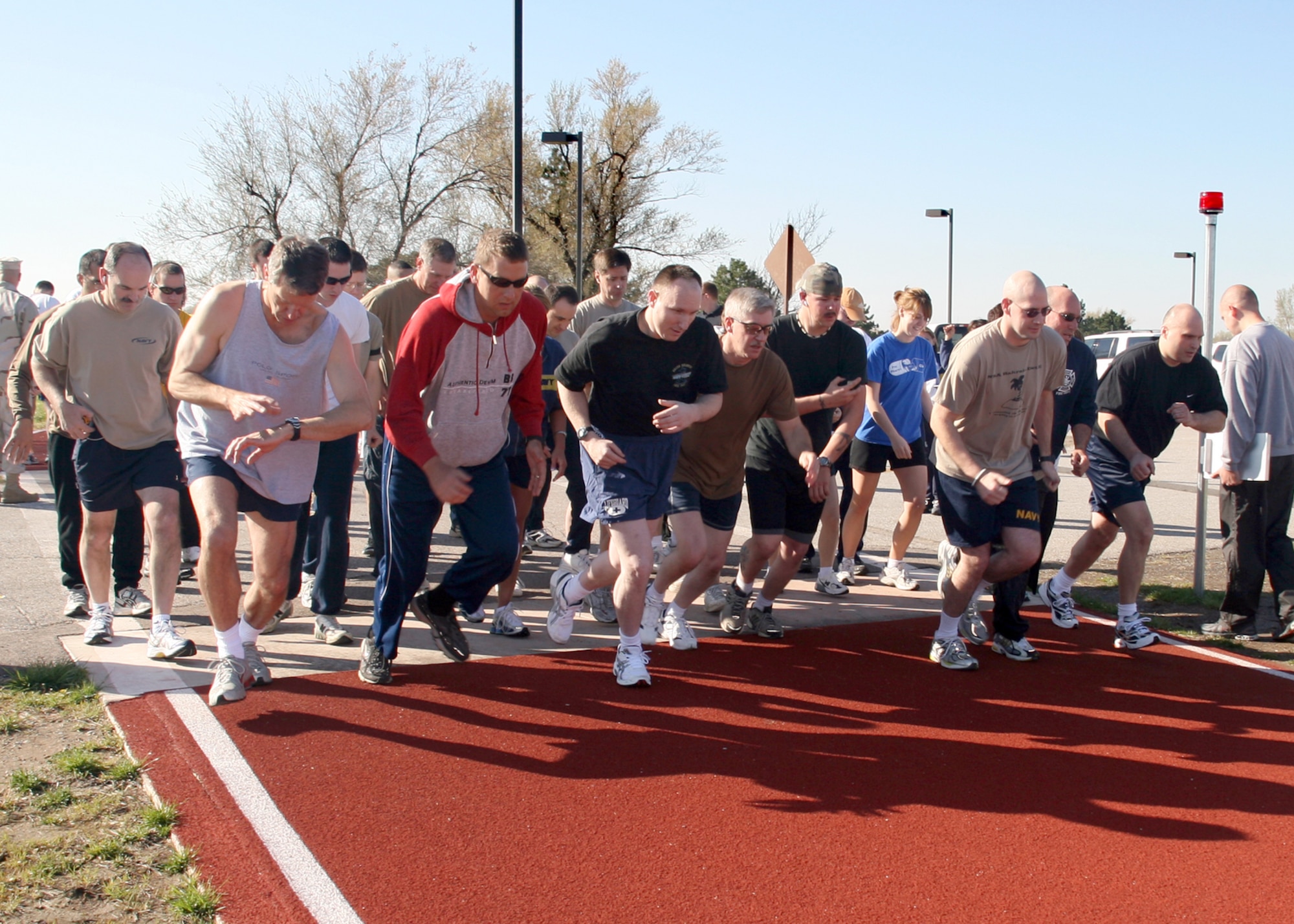 NAVY OPERATIONAL SUPPORT CENTER, Kan. -- Members of the Navy Operational Support Center, Wichita, begin a 1.5-mile run during their semi-annual physical fitness assessment at McConnell. (Navy photo by Petty Officer 2nd Class Ron Trevino)


