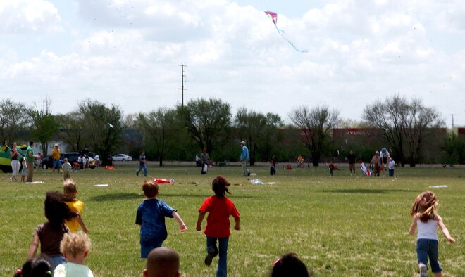 CANNON AIR FORCE BASE, N.M. - Children sprint for the pile of candy dropped from a kite during the 4th Annuall Kite Karnival at Cannon April 27. According to Community Center officials, more than 1,300 children and adults from the base and local communities attended  the festivites. (U.S Air Force photo by Airman 1st Class Thomas Trower)                   