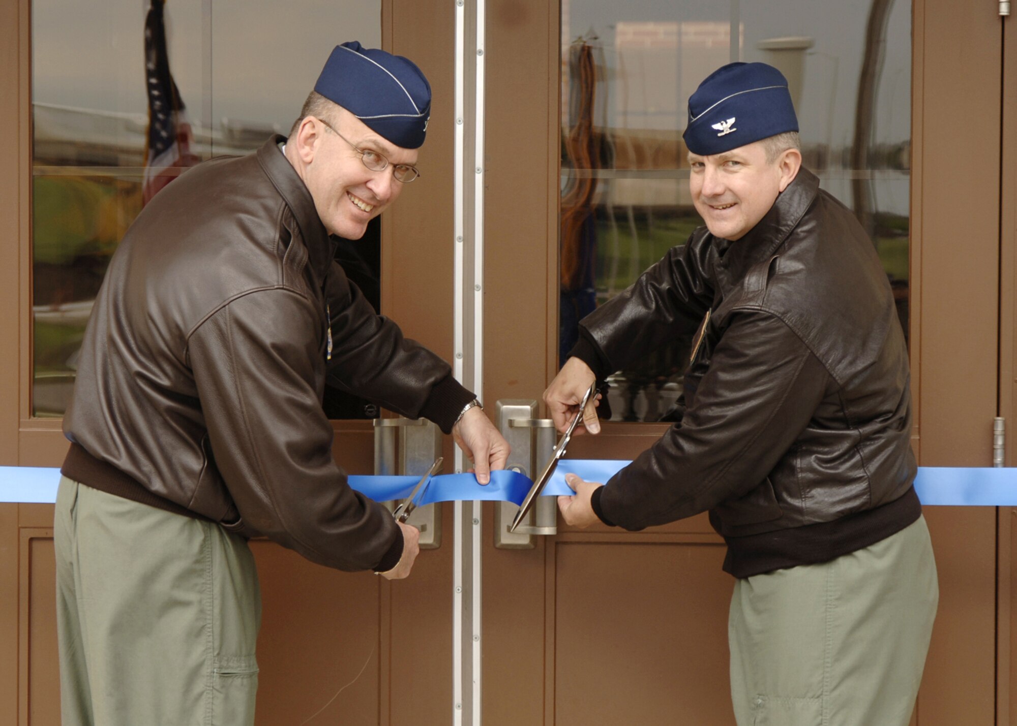 Col. Donald J. Halpin, right, 22nd Air Refueling Wing commander, and Col. Ray, Lamarche, 22nd Operations Group commander participate in ribbon cutting ceremony, April 27, to inaugurate the newly renovated building 1218. The renovations made to the building, which headquarters the 22nd operations group, include; new carpeting and light fixtures and freshly painted walls. Renovators also made improvements to the landscaping, sidewalk and parking lot outside the building. ((Photo by Airman 1st Class Laura Suttles 22nd Communications Squadron)