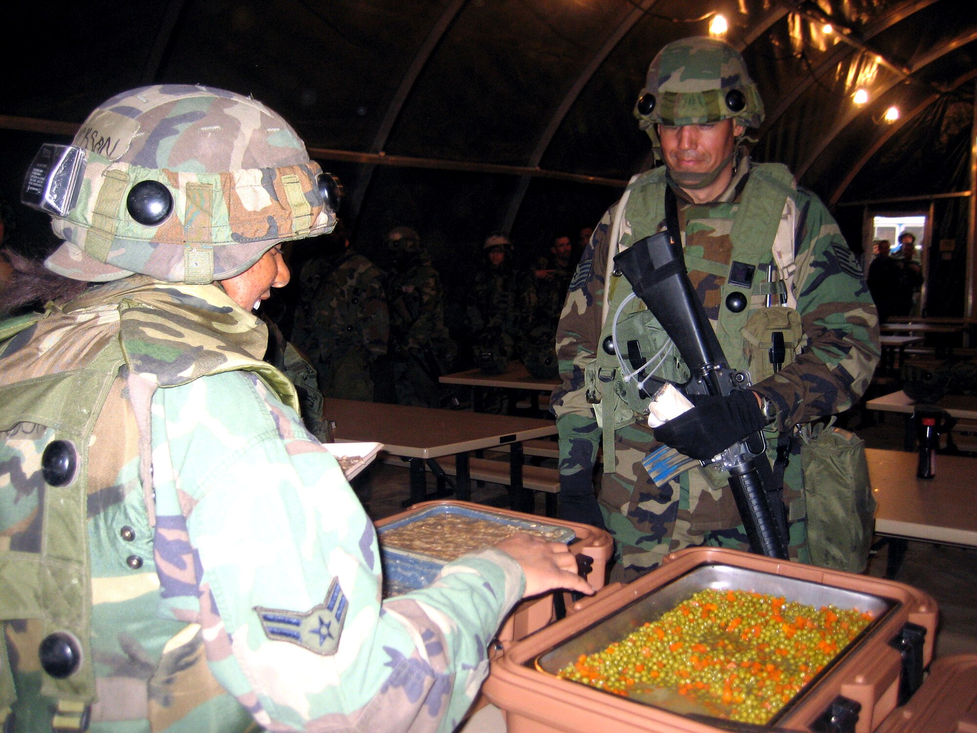 Services Airmen deployed to Air Force exercise Eagle Flag 07-4 serve up food to exercise participants April 25 during an evening meal at Naval Air Engineering Station at Lakehurst, N.J. Services members prepared the food in the Single Pallet Expeditionary Kitchen, or SPEK. During each Eagle Flag exercise, more than 30 services Airmen deploy to support the exercise operated by the Air Force Expeditionary Center's 421st Combat Training Squadron. (U.S. Air Force photo/Senior Airman Jared Marquis)