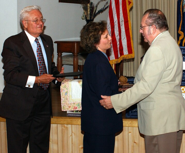 Col. Sandy Finan, 341st Space Wing commander, congratulates Jim Thul for being selected as the volunteer of the year by the Retirees Council while Stephen Kubick, Malmstrom’s retirees affairs officer, waits to present him a plaque. The award was presented at the retiree’s dinner Saturday at the Grizzly Bend Club. 