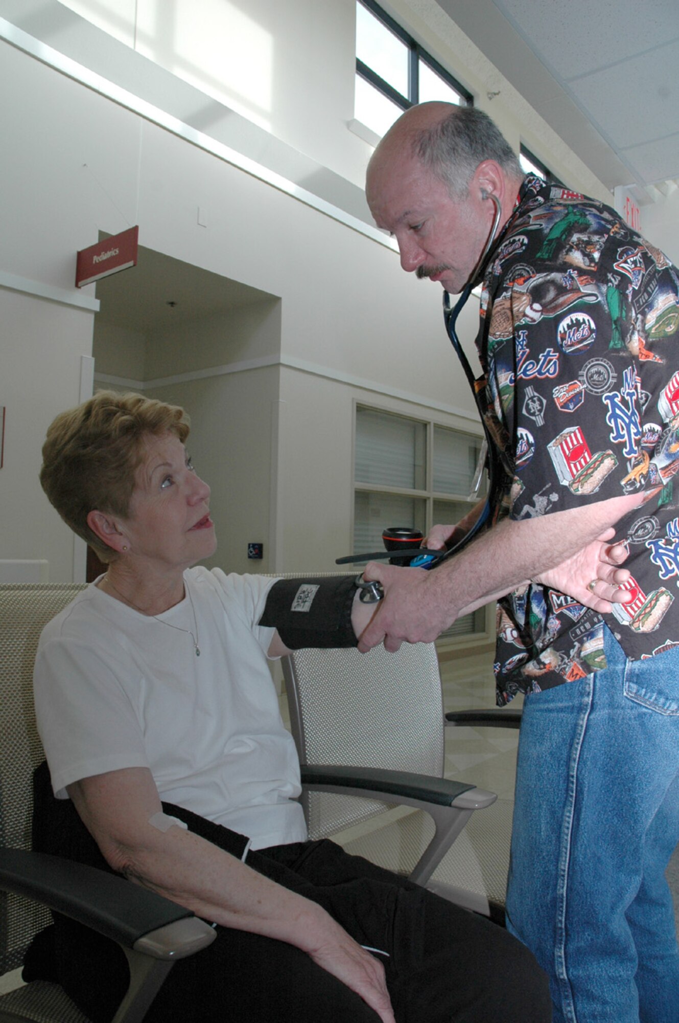 Marilyn Taylor gets her blood pressure checked by Mike Hryszko at the Malmstrom clinic Saturday. Blood pressure checks were one of many services offered free to retirees that day. 
