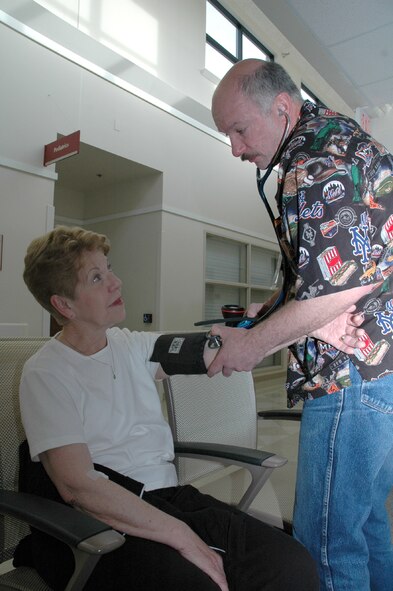 Marilyn Taylor gets her blood pressure checked by Mike Hryszko at the Malmstrom clinic Saturday. Blood pressure checks were one of many services offered free to retirees that day. 