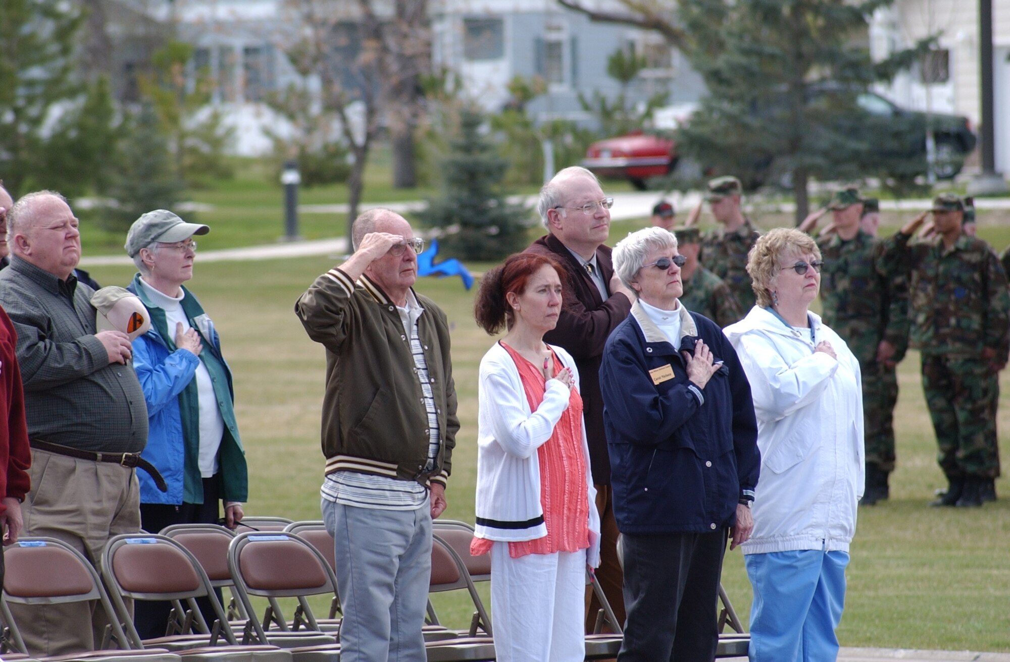 Left to right: Retired Senior Master Sgt. Al Maflin, Mary Ann Mackall, retired Colonel Fred Rauch, Carol Nielson and Rose Maflin pay their respect to the flag during the retiree retreat ceremony Friday at Medal of Honor Park. The event marked the kick-off of Retiree Appreciation Weekend at Malmstrom. (U.S. Air Force photo / Valerie Mullett
)