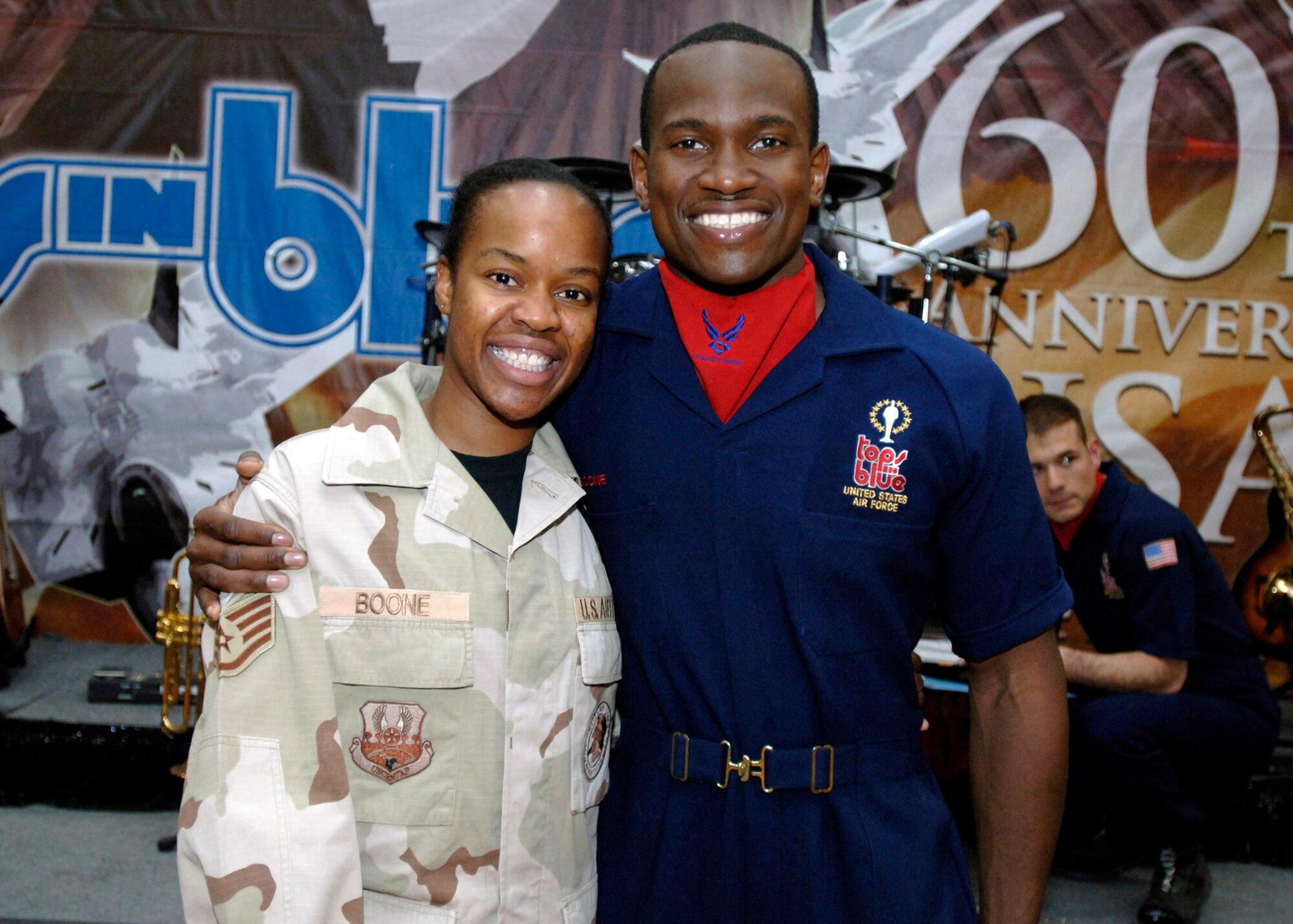 Deployed Staff Sgt. Kara Boone gets a hug from her brother Staff Sgt. Wendell Boone a member of the all active-duty Air Force special unit,Tops in Blue, who are touring Southwest Asia. Tops in Blue entertained the 386th Air Expeditionary Wing May 2 at an undisclosed location. The group's main mission is to perform for military personnel and their families throughout the world. (U.S. Air Force photo/Tech Sgt. Edward D. Holzapfel)