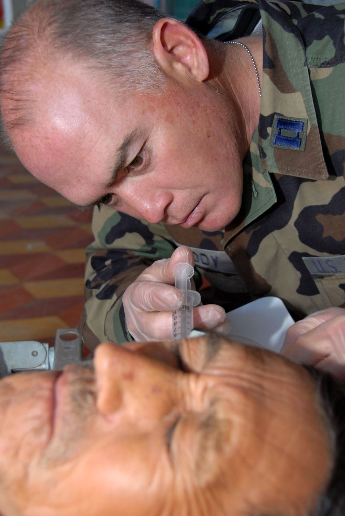 Capt. Michael Priddy irrigates the ear canal a Guatemalan patient during the New Horizons Medical Readiness Training Exercise conducted April 14 through 28 in the region of San Marcos, Guatemala. Captain Priddy is a physician assistant with the 445th Aerospace Medicine Squadron, Wright Patterson Air Force Base, Ohio. (U.S. Air Force photo/Master Sgt. Chance C. Babin)
