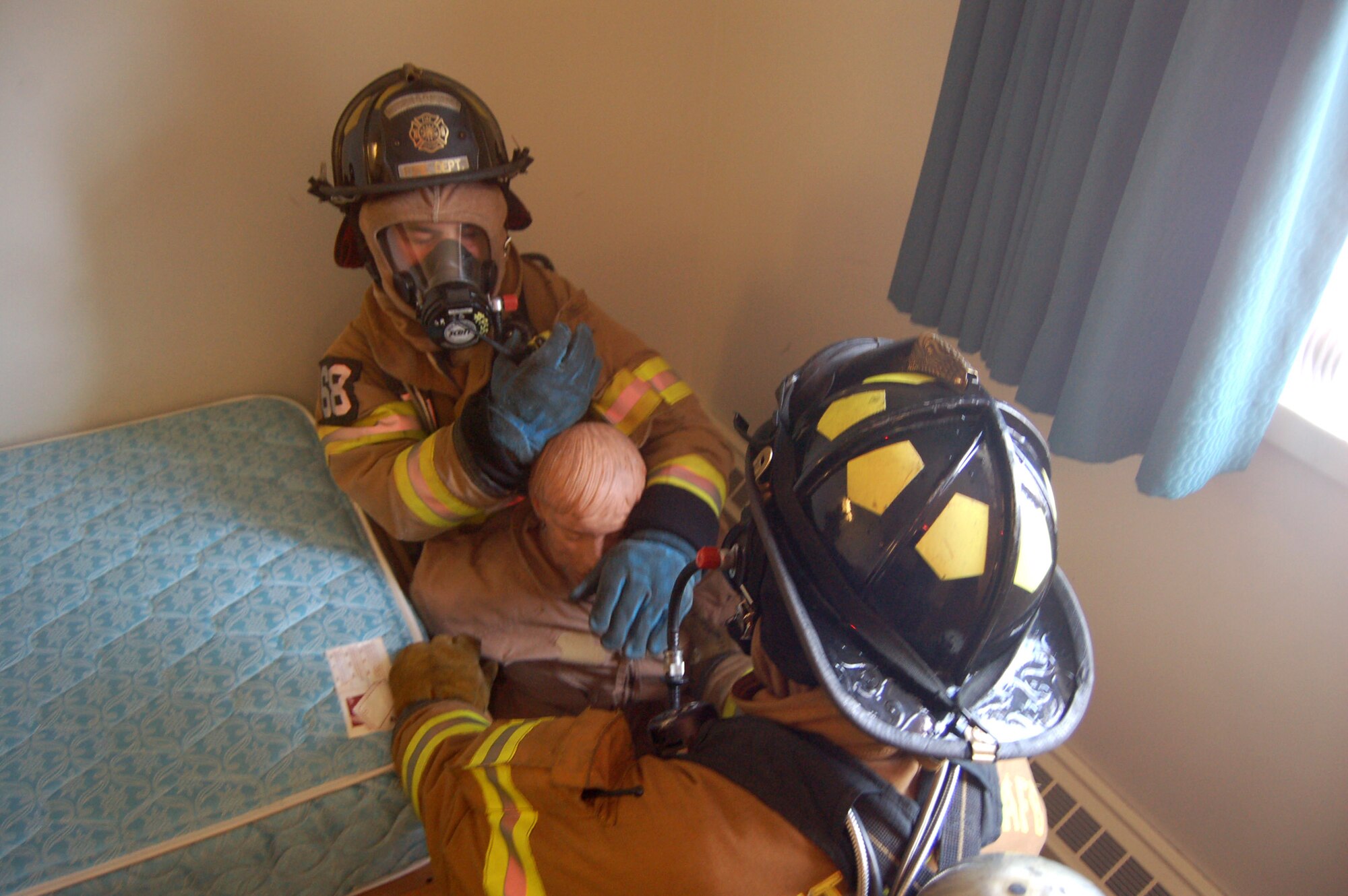 Tech. Sgt. Chancey Cruger prepares to lift a simulated victim during a firefighting exercise April 10 at Peterson Air Force Base, Colo. The training is essential to keeping the firefighters sharp and ready to perform their duties at a moment's notice. (U.S. Air Force photo/Staff Sgt. Jeremy Larlee)
