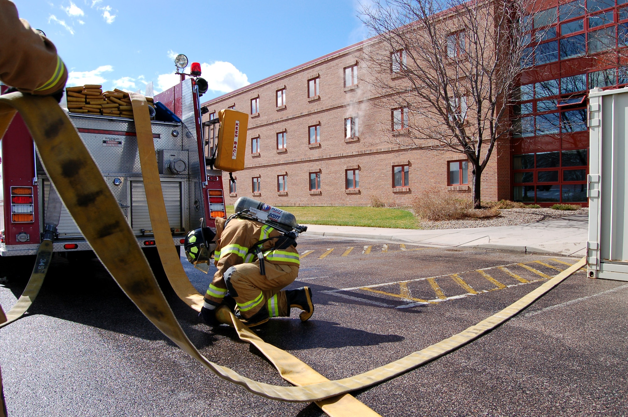 A firefighter disconnects a large diameter hose during a firefighting exercise April 10 at Peterson Air Force Base, Colo. The training is essential to keeping the firefighters sharp and ready to perform their duties in a moment's notice.(U.S. Air Force photo/Staff Sgt. Jeremy Larlee)
