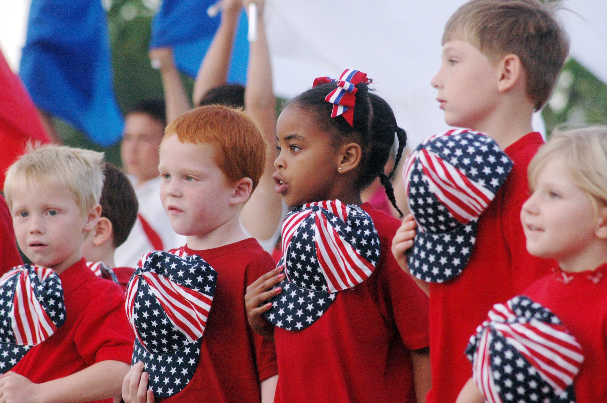 Kindergarten students sing about taking your hat off for the flag. U. S. Air Force photo by Sue Sapp