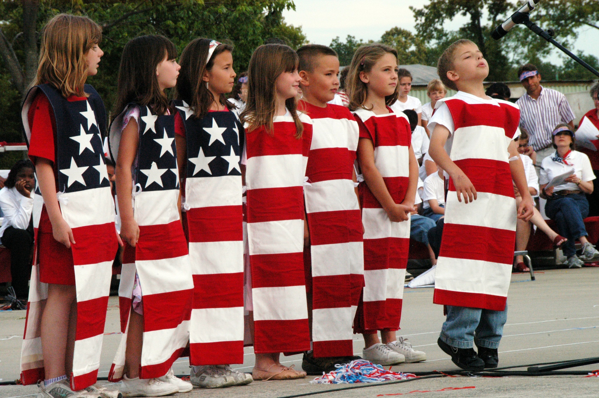 Robins Elementary 2nd grade students, Lauren Wozniak, Kinsey Smith, Bailey Smith, Alyssa Toellner, Jaedan Pacheco, Cori Calvert and Drew Schuler, explain the meaning of the pledge of allegiance. U. S. Air Force photo by Sue Sapp   