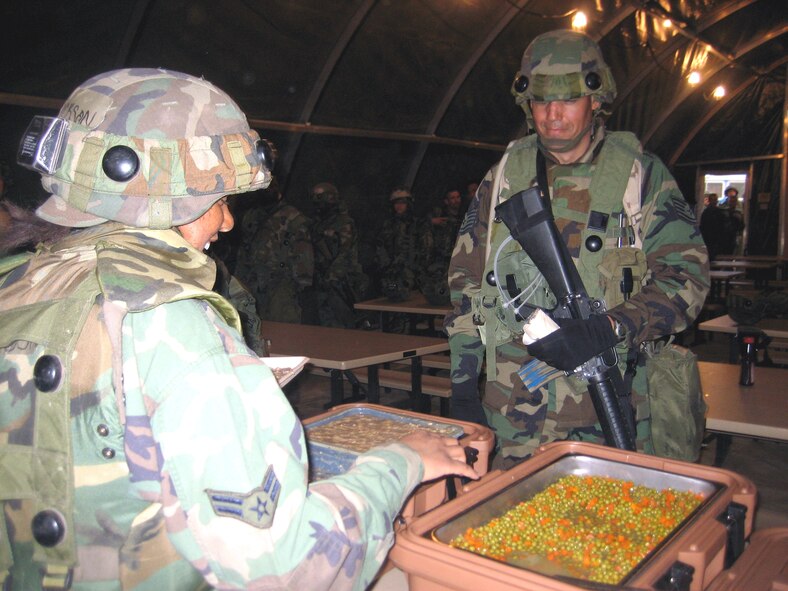 U.S. Air Force Airmen deployed to Air Force Exercise Eagle Flag 07-4 serve up food to exercise students during an evening meal April 25, 2007, at Naval Air Engineering Station Lakehurst, N.J.  The food was prepared in the Single Pallet Expeditionary Kitchen, or SPEK, by services Airmen.  During each Eagle Flag, more than 30 Airmen deploy to support the exercise.  The exercise is operated by the U.S. Air Force Expeditionary Center's 421st Combat Training Squadron.  (U.S. Air Force Photo by Senior Airman Jared Marquis)