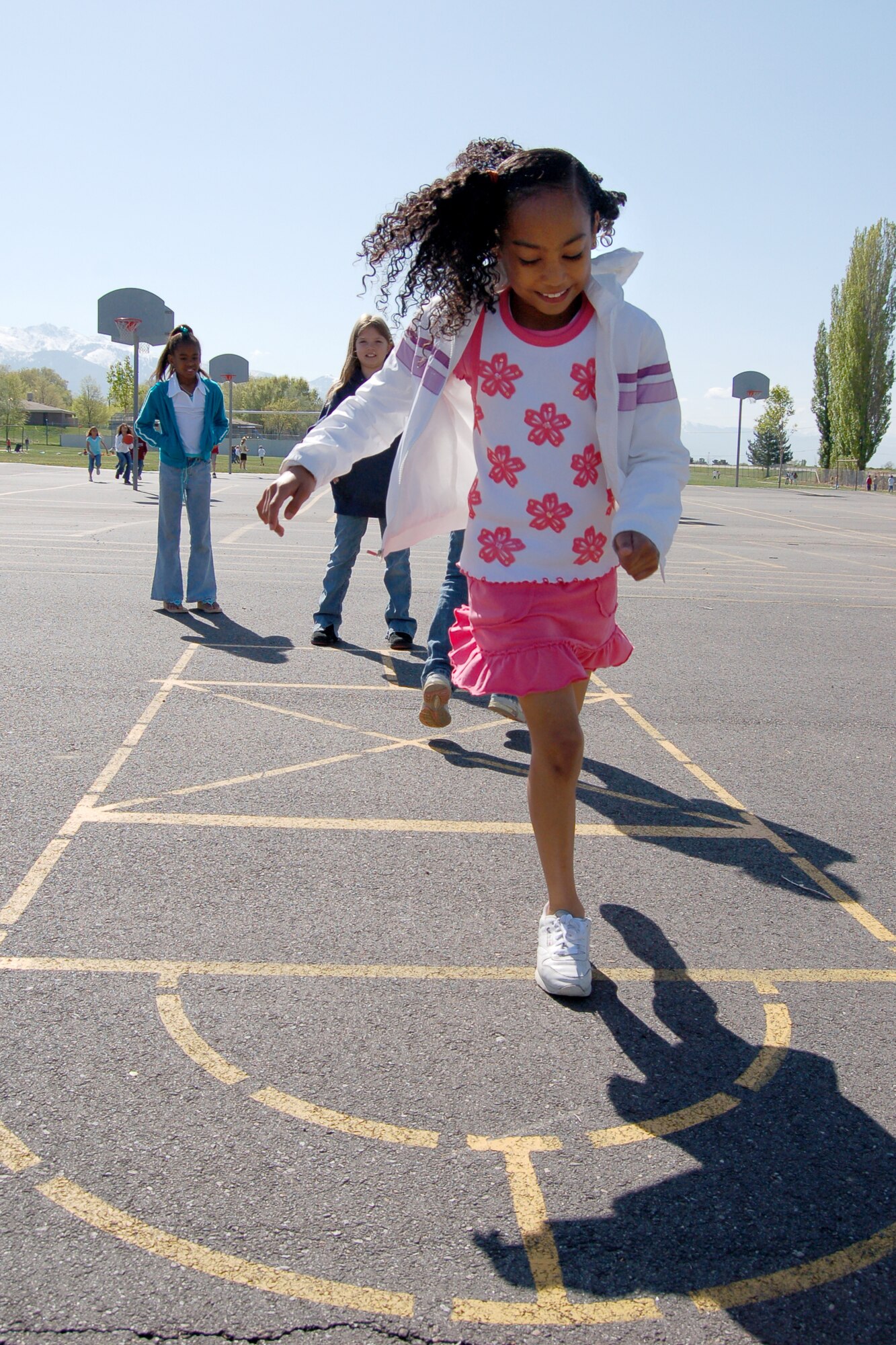 Desiree Palacios, Hill Field Elementary school student, plays hopscotch during recess. Playground games such as these are a good way for children to get exercise. For more about children’s fitness, turn to page five. Photo by Beth Young 
