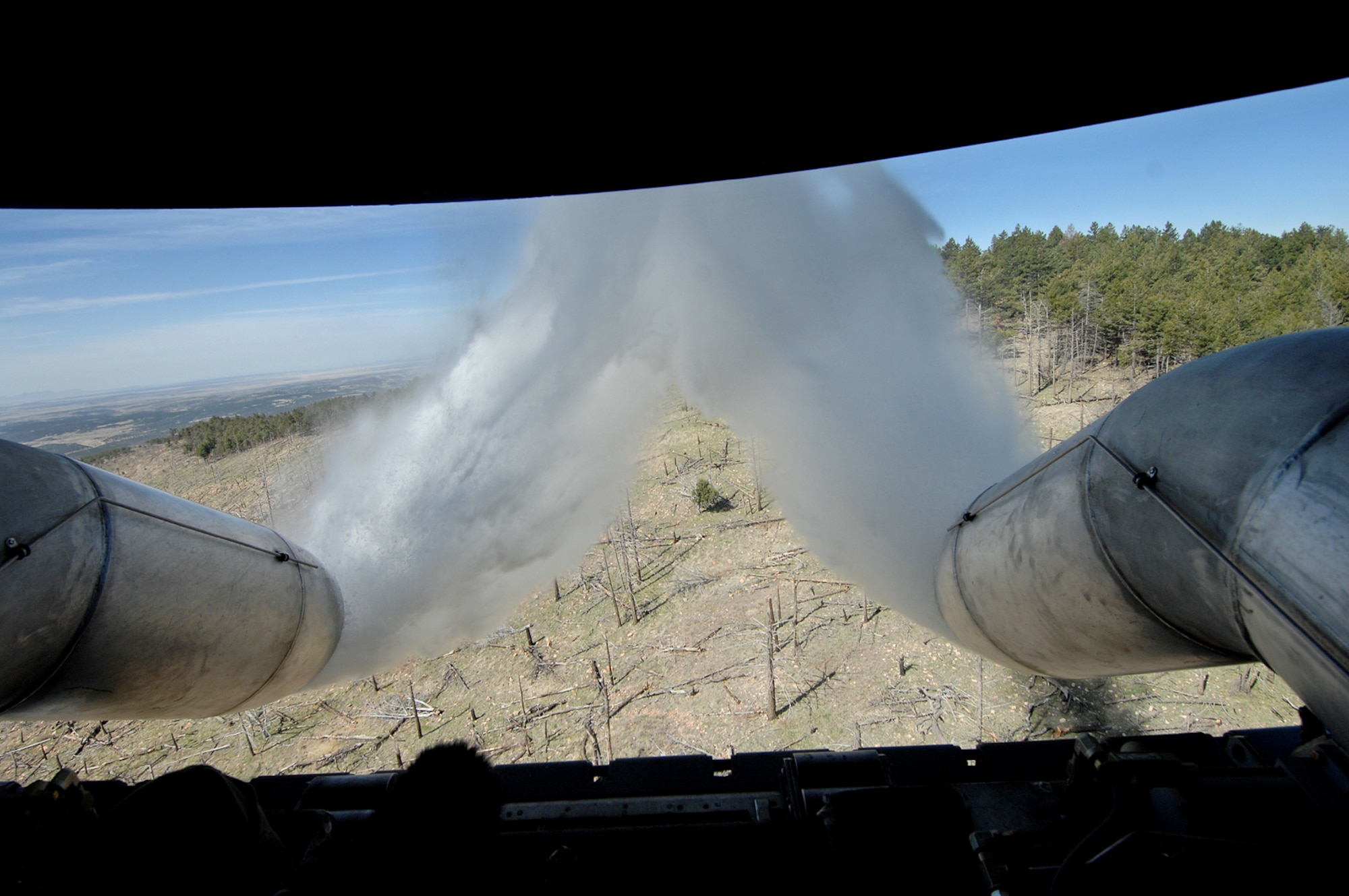 A C-130 Hercules from the 302nd Airlift Wing, Peterson Air Force Base, Colo., drops water over New Mexico during annual Modular Airborne Fire Fighting System training at the U.S. Forest Service's Albuquerque Air Tanker Base in New Mexico.  (U.S. Air Force photo/Tech. Sgt. Rick Sforza)