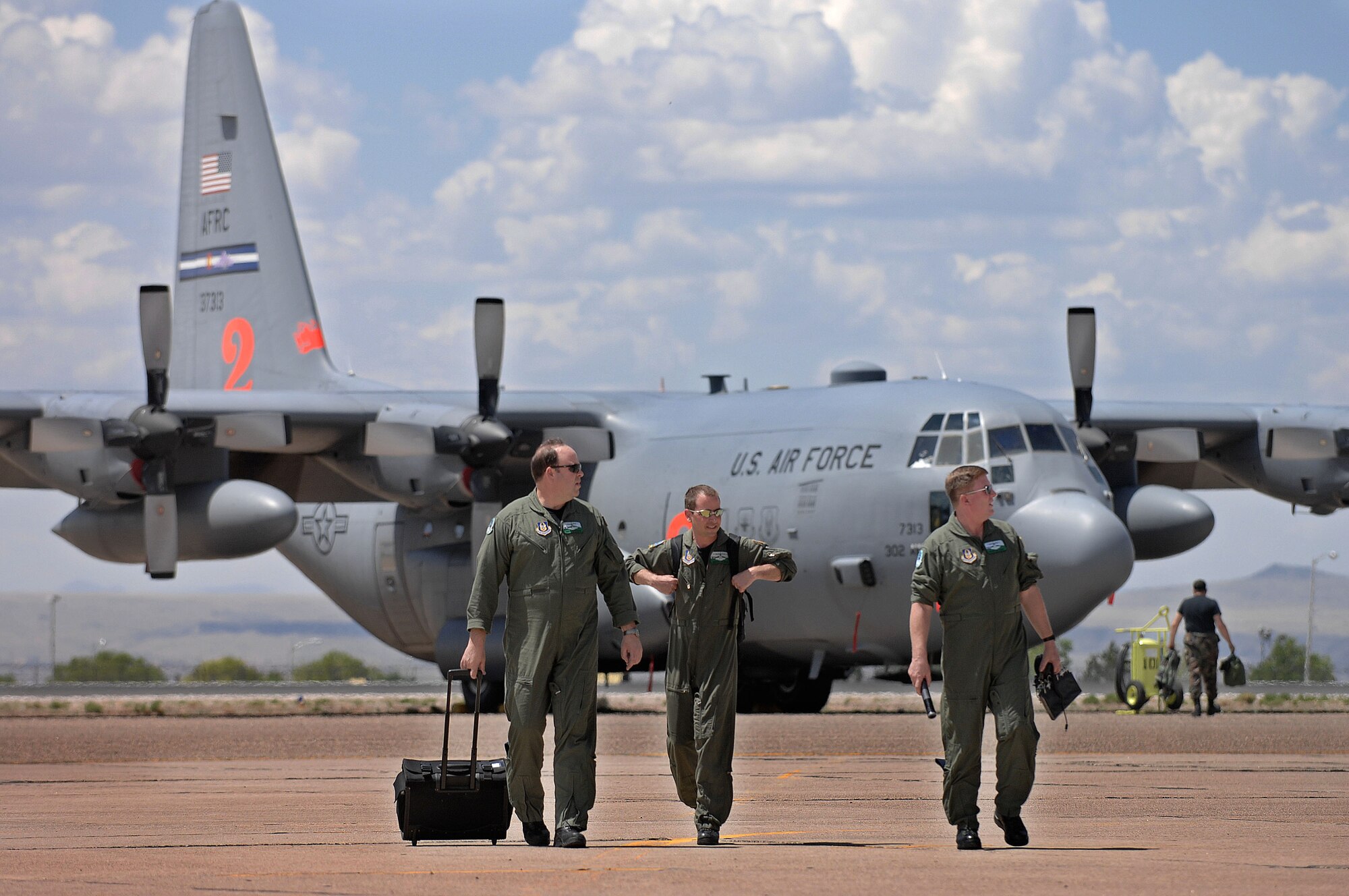 From left, Master Sgt. Tim McWilliams, Senior Master Sgt. Jim Rucker and Senior Master Sgt. Dave Carey, all flight engineers from the 731st Airlift Squadron, 302nd Airlift Wing, Peterson Air Force Base, Colo., finish a day of training.  C-130 aircrews from the Air Force Reserve Command unit and Air National Guard units began arriving April 30, 2007, for the first day of Modular Airborne Fire Fighting System training at the U.S. Forest Service's Albuquerque Air Tanker Base in New Mexico.  (U.S. Air Force photo/Tech. Sgt. Rick Sforza)