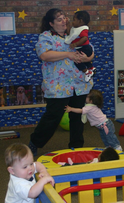 Tammy Daulton cares for babies less than 1 year old in Room 121 at the Child Development Center. (U.S. Air Force photo/Staff Sgt Tonnette Thompson)