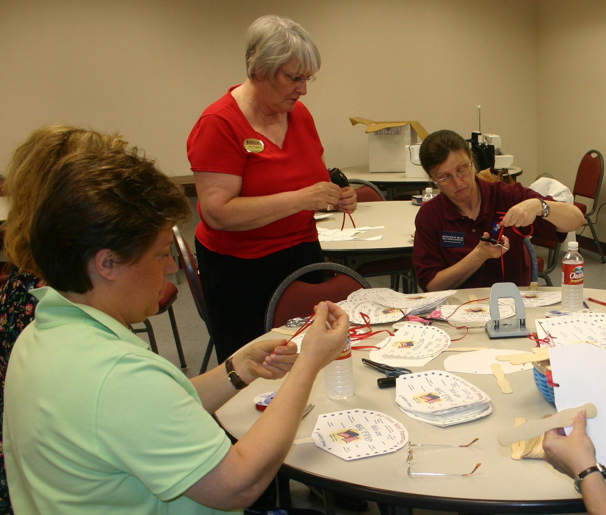 Members of the Military Spouse Appreciation committee create fans.  The fans will be distributed at the Miltary Spouse Appreciation Day event at the Community Activity Center May 11. (U.S. Air Force photo/Staff Sgt. Tonnette Thompson) 