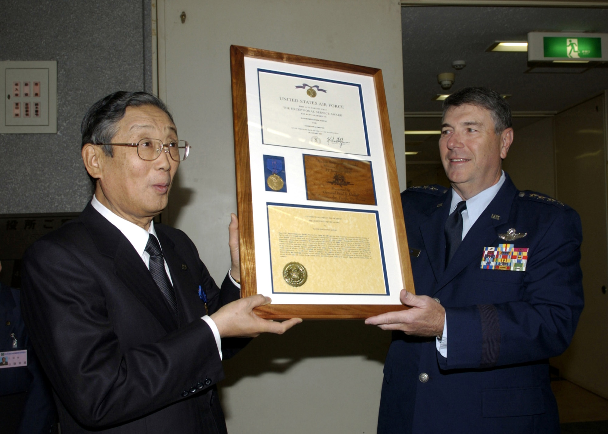 Gen. Paul V. Hester presents the Air Force Exemplary Civilian Service award to Misawa City Mayor Shigeyoshi Suzuki Jan. 31 in Misawa City, Japan. It was the first time a Japanese official was presented with an Air Force-level award. General Hester is the Pacific Air Forces commander. Mayor Suzuki, a longtime friend and supporter of American servicemembers, their families and the Air Force mission in Northern Japan, passed away May 1 from pneumonia at the age of 66. Mayor Suzuki served as mayor of Misawa City, representing a city of 40,000, for more than two decades and was in his sixth term upon his death. Throughout his years as mayor, he laid the foundation for strong relations between the base and the local area. (U.S. Air Force photo/Senior Airman Robert Barnett) 