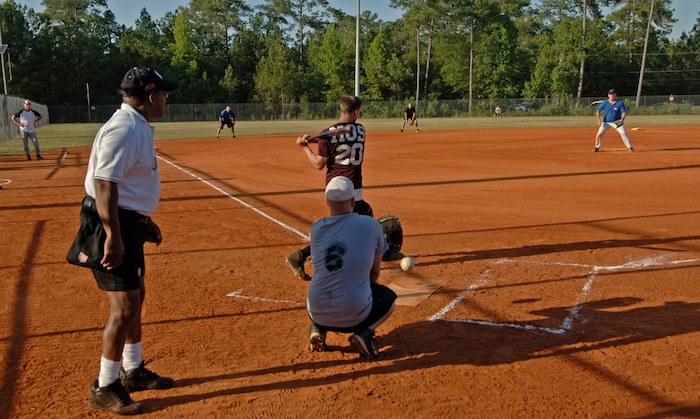 437th Maintence Squadron 1 pitcher slides one past Staff Sgt. Joseph Sparlin, MOS ..."Strike One!"  (U.S. Air Force photo/Staff Sgt. April Quintanilla)