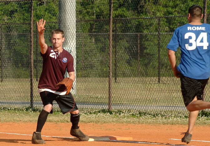 Staff Sgt. Joseph Sparlin Maintence Operation Squadron eagerly waits for his team to throw him the ball to tag the runner out. (U.S. Air Force photo/Staff Sgt. April Quintanilla)