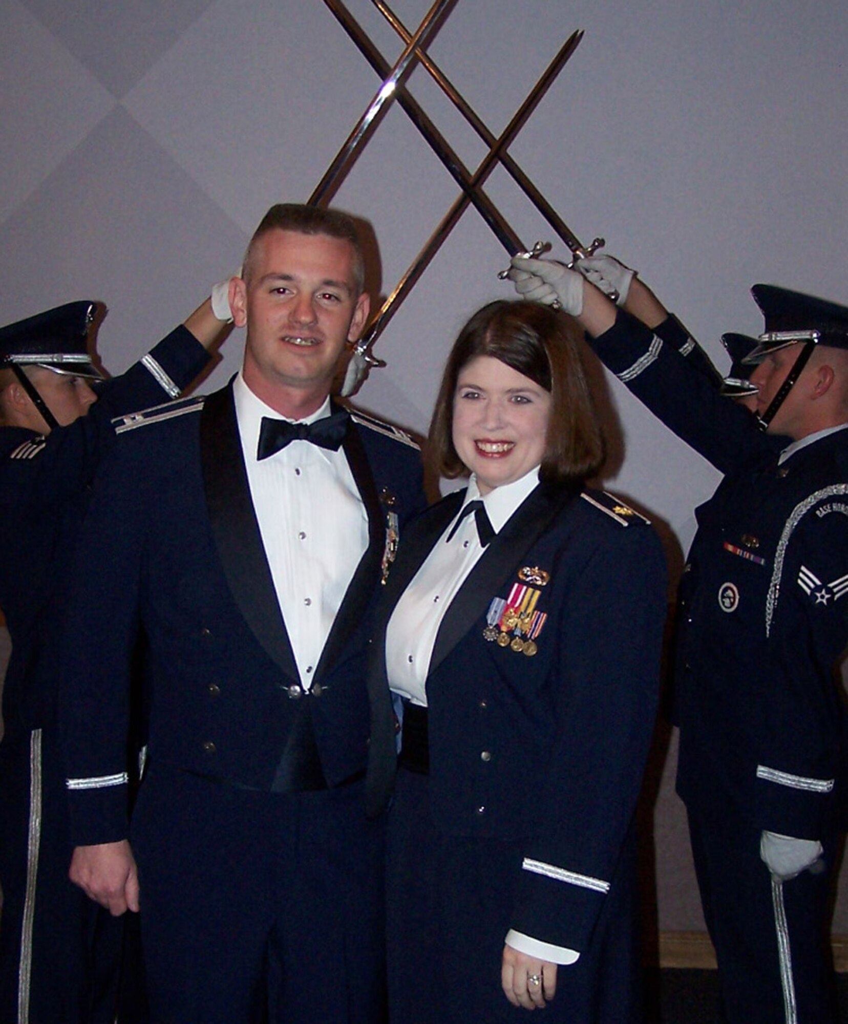 Capt. Christopher and wife Maj. Kimberly Tooman, both assigned to the 35th Fighter Wing Misawa Air Base, Japan take a moment to pose for a picture after the graduation ceremony following the Advanced Maintenance and Munitions Officer School. The AMMOS, located at Nellis Air Force Base, Nev., is a 14 week course offered to maintenance officers.